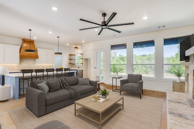 505 Aermotor Loop, Weatherford, TX 76085 - living area featuring a ceiling fan, recessed lighting, light wood-type flooring, and a stone fireplace