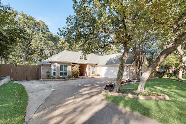 ranch-style house featuring a front yard and a garage