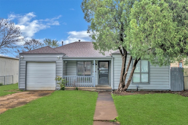 view of front of house with a front yard and a garage