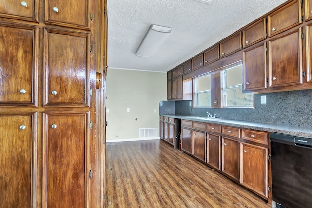 kitchen with sink, dishwasher, hardwood / wood-style floors, crown molding, and decorative backsplash