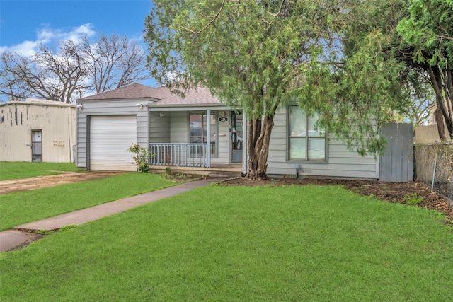 view of front of home featuring a porch, a front lawn, and a garage