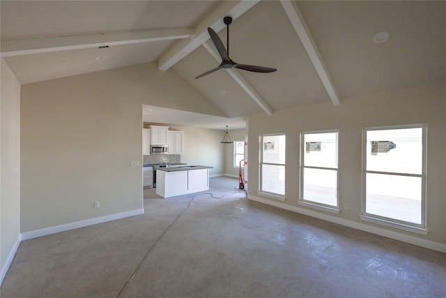 unfurnished living room with beam ceiling, high vaulted ceiling, and ceiling fan with notable chandelier