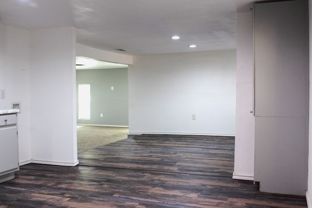 spare room with dark wood-type flooring