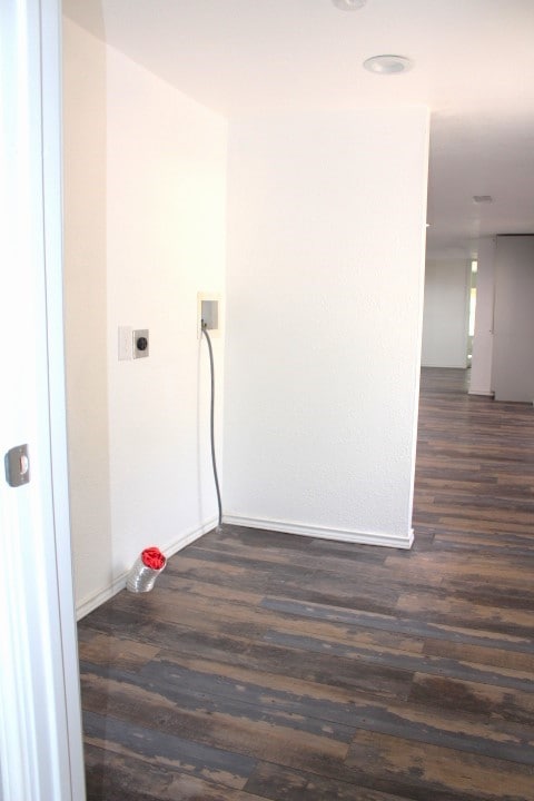 laundry area featuring hookup for an electric dryer, washer hookup, and dark hardwood / wood-style flooring