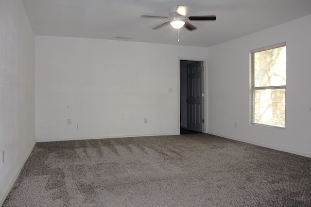 carpeted spare room with ceiling fan