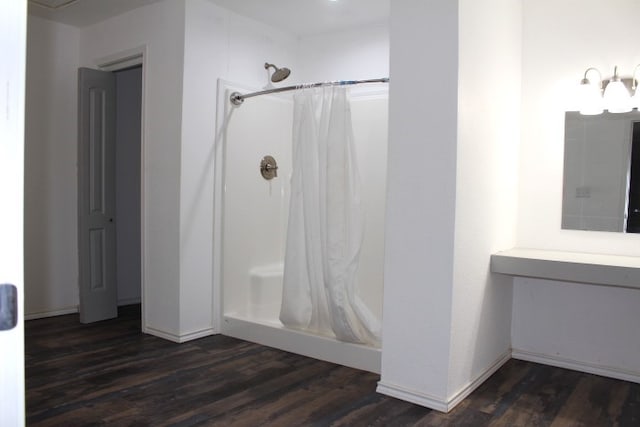 bathroom featuring vanity, curtained shower, and wood-type flooring