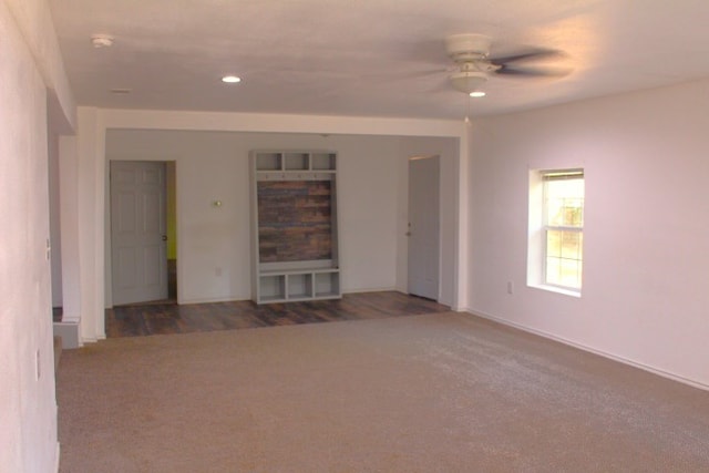 unfurnished room featuring dark wood-type flooring and ceiling fan