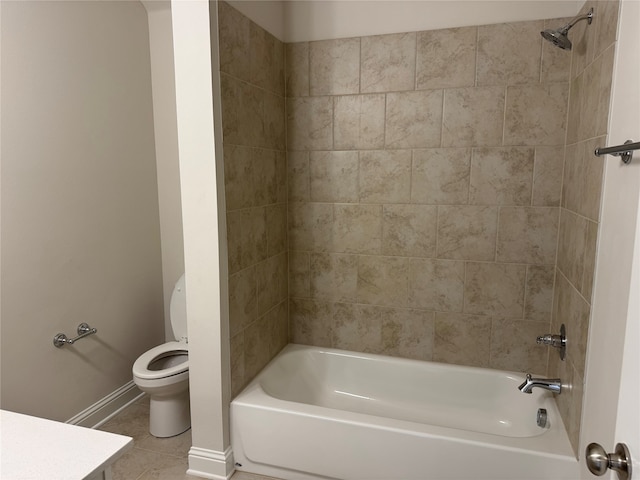 full bathroom with toilet, tiled shower / bath, vanity, and tile patterned floors