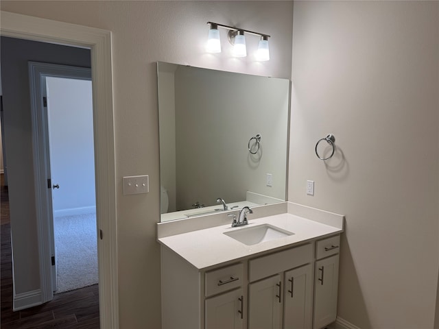 bathroom with vanity, hardwood / wood-style floors, and toilet