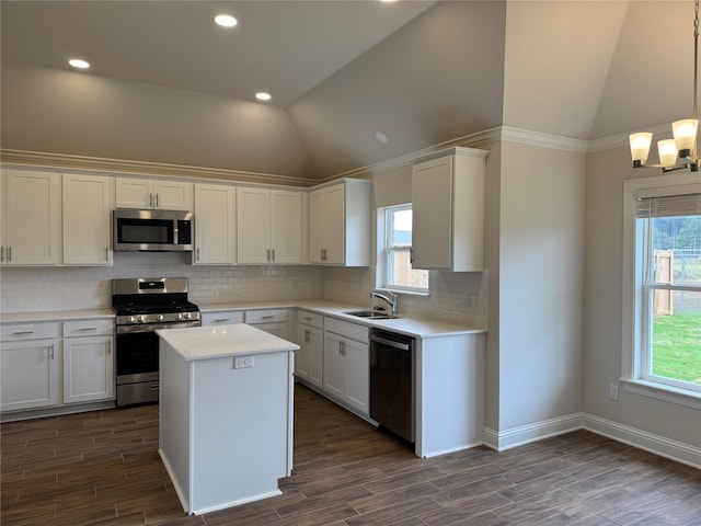 kitchen featuring a wealth of natural light, appliances with stainless steel finishes, pendant lighting, and white cabinetry