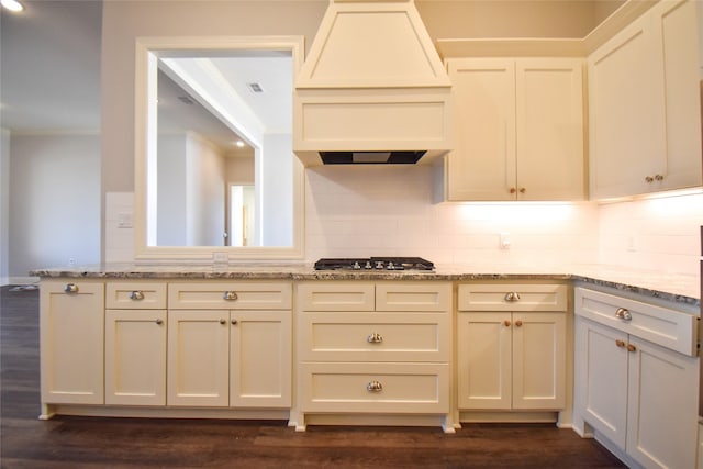 kitchen with crown molding, custom exhaust hood, light stone countertops, and stainless steel gas stovetop