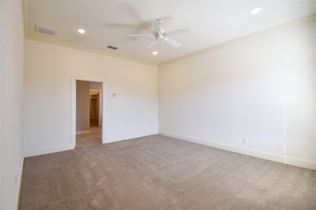 spare room featuring crown molding, ceiling fan, and carpet floors