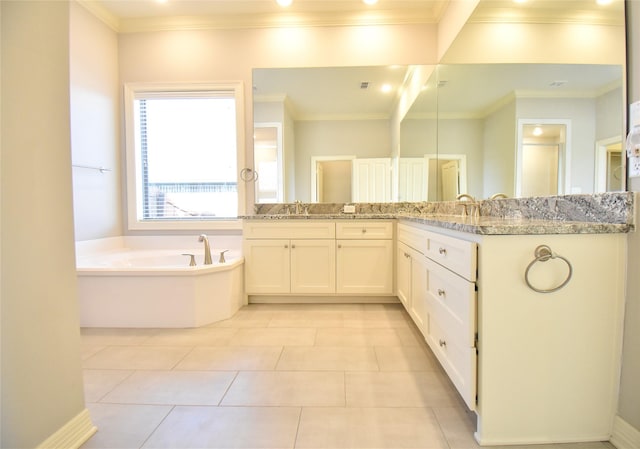 bathroom with ornamental molding, vanity, and a bathtub