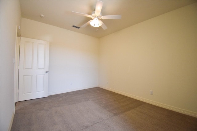 unfurnished room featuring ceiling fan and dark colored carpet