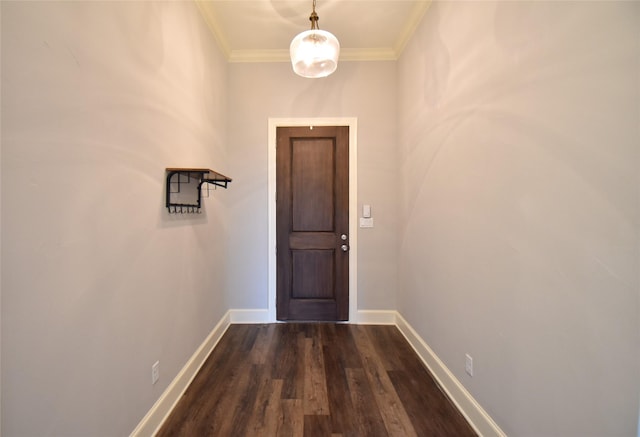 entryway with dark wood-type flooring and ornamental molding