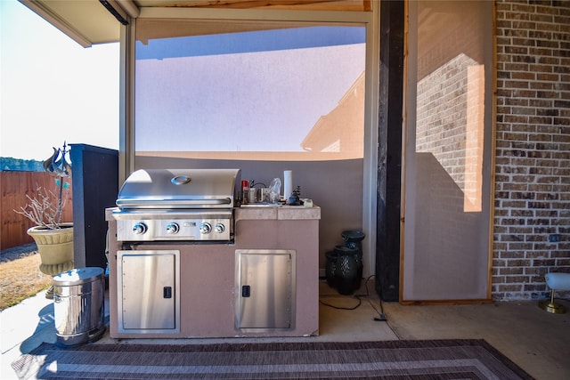 view of patio with an outdoor kitchen and area for grilling