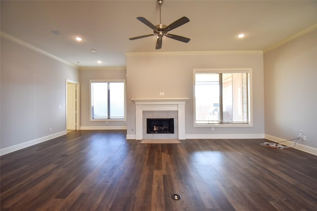 unfurnished living room with dark wood-type flooring, ceiling fan, ornamental molding, and a fireplace