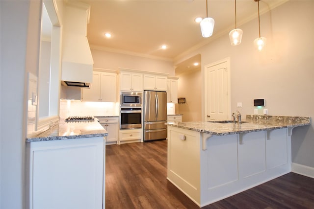 kitchen featuring white cabinetry, sink, decorative light fixtures, and appliances with stainless steel finishes