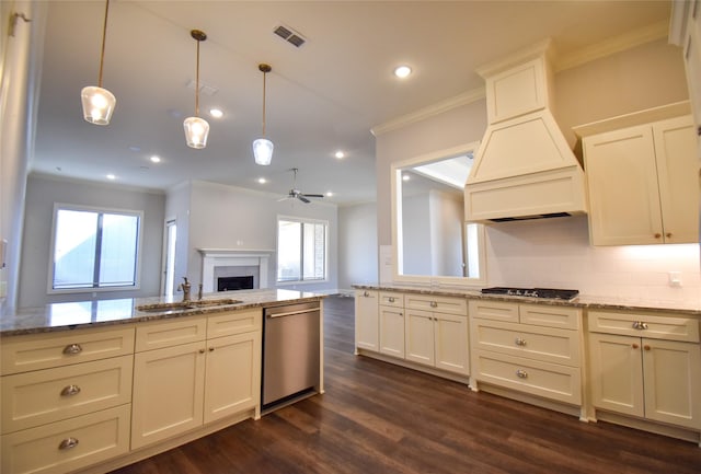 kitchen with sink, hanging light fixtures, ornamental molding, stainless steel dishwasher, and light stone counters