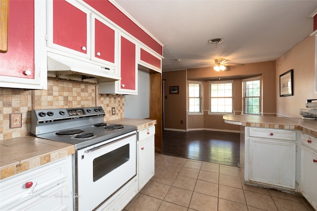 kitchen featuring white cabinets, tasteful backsplash, ceiling fan, light tile patterned floors, and white electric range