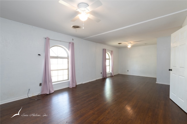 unfurnished room with dark hardwood / wood-style flooring and ceiling fan