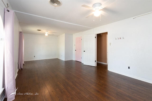 empty room with dark wood-type flooring and ceiling fan