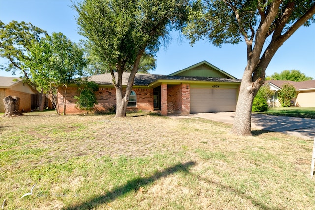 single story home featuring a front lawn and a garage