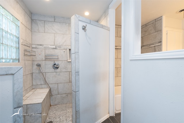 bathroom featuring independent shower and bath