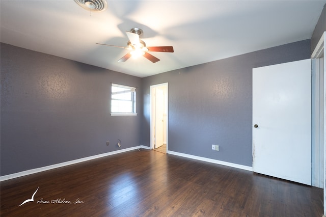 unfurnished room featuring dark hardwood / wood-style floors and ceiling fan