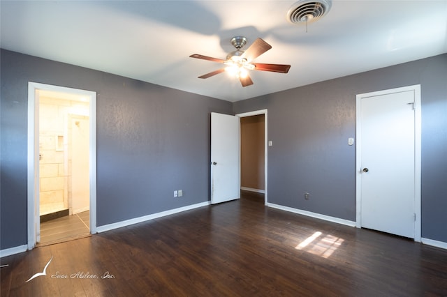 unfurnished bedroom featuring dark hardwood / wood-style floors, connected bathroom, and ceiling fan