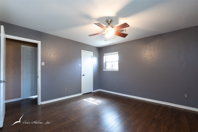 unfurnished room with dark wood-type flooring and ceiling fan