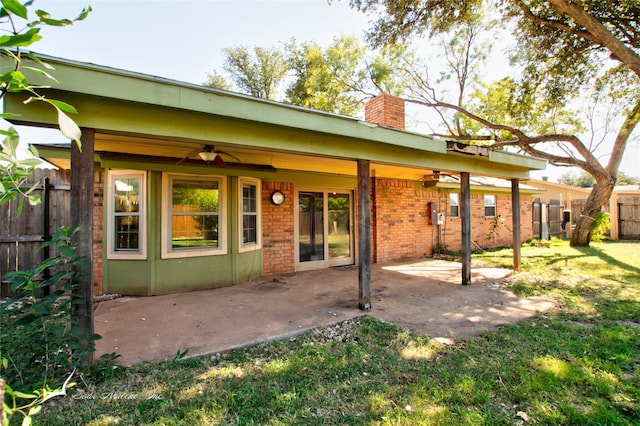 rear view of house featuring a yard, a patio area, and ceiling fan