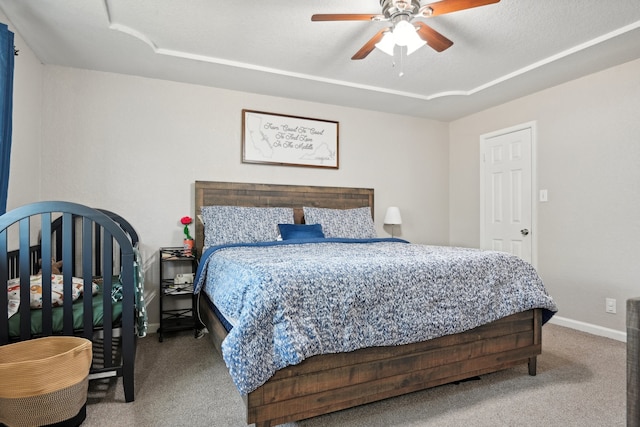 bedroom featuring carpet floors, a textured ceiling, and ceiling fan