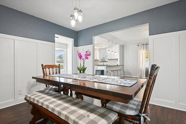 dining area with dark hardwood / wood-style flooring