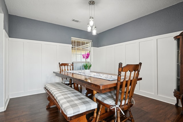 dining space with dark hardwood / wood-style flooring