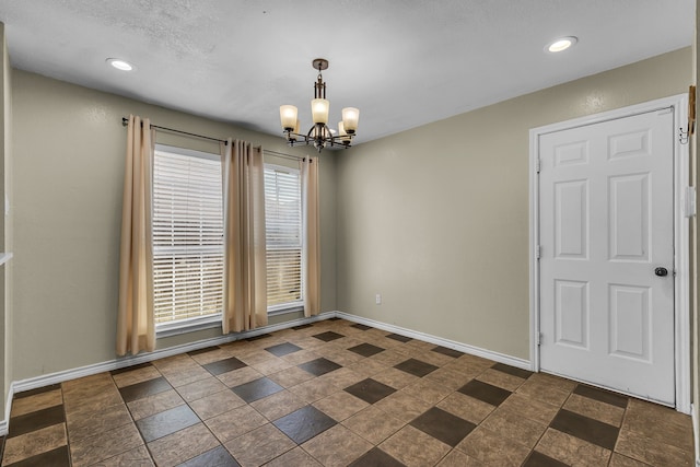 spare room with an inviting chandelier