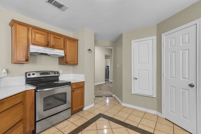 kitchen featuring stainless steel electric range oven and light tile patterned floors