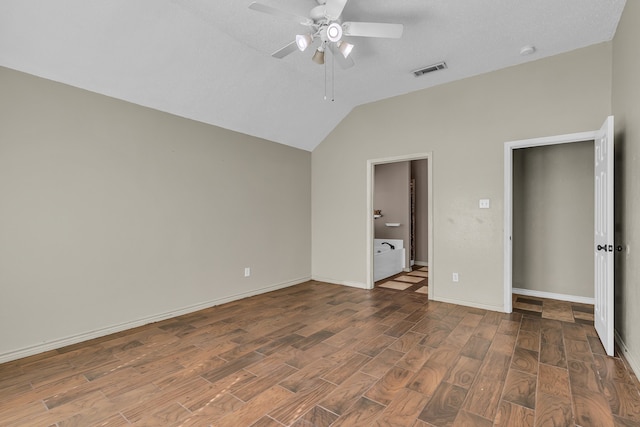 unfurnished bedroom with dark hardwood / wood-style flooring, a textured ceiling, ceiling fan, and vaulted ceiling