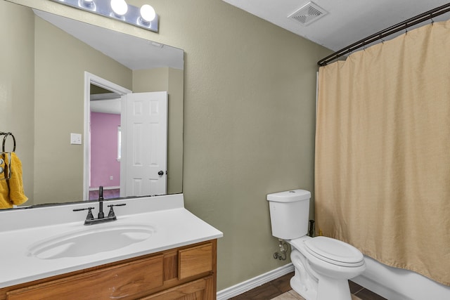 full bathroom featuring vanity, shower / bath combination with curtain, and toilet