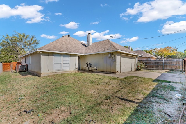 rear view of house featuring a patio area, a garage, and a lawn