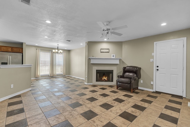 unfurnished living room with ceiling fan with notable chandelier