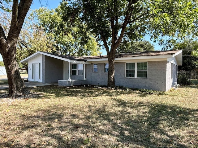 back of property featuring a lawn