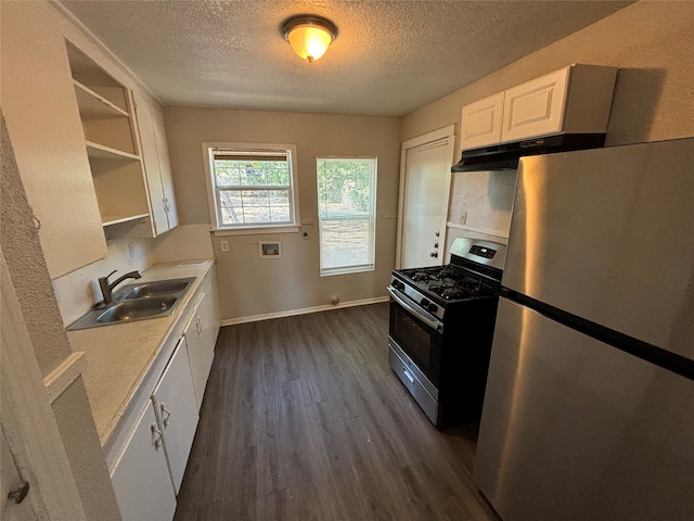 kitchen featuring appliances with stainless steel finishes, sink, a textured ceiling, white cabinets, and dark wood-type flooring