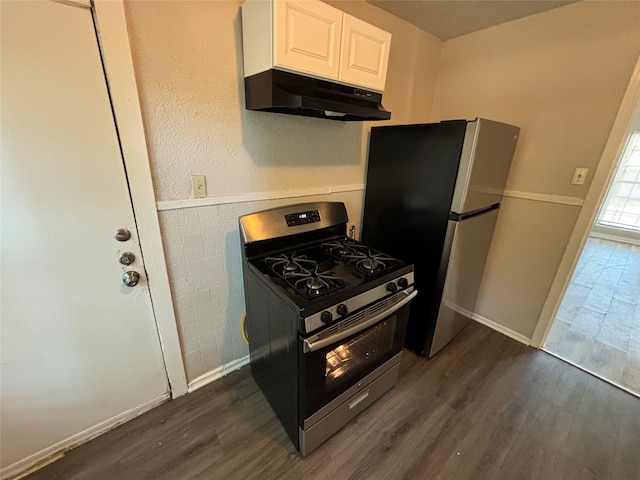 kitchen featuring dark wood-type flooring, appliances with stainless steel finishes, and white cabinets