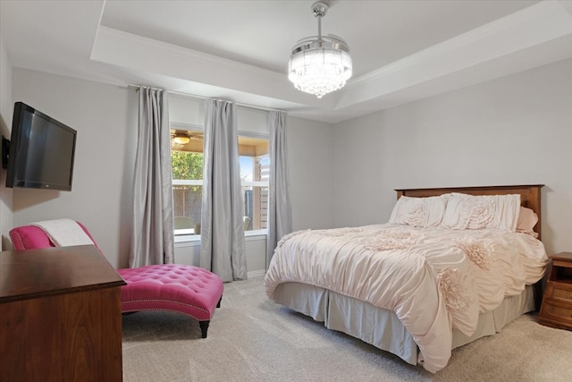 bedroom with light carpet and a tray ceiling