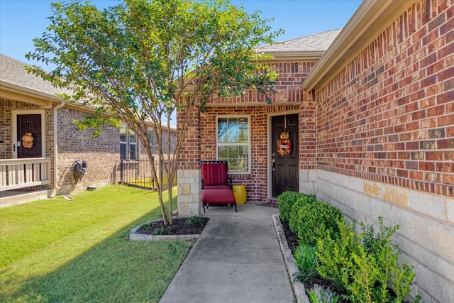 entrance to property featuring a lawn