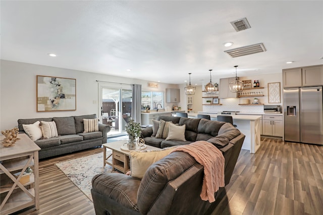 living room featuring a notable chandelier and hardwood / wood-style flooring