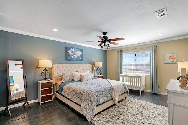 bedroom featuring ceiling fan, dark hardwood / wood-style floors, and ornamental molding