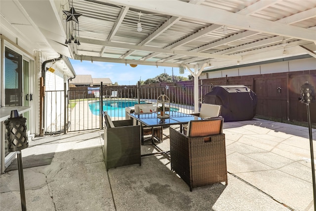 view of patio / terrace with a fenced in pool and grilling area