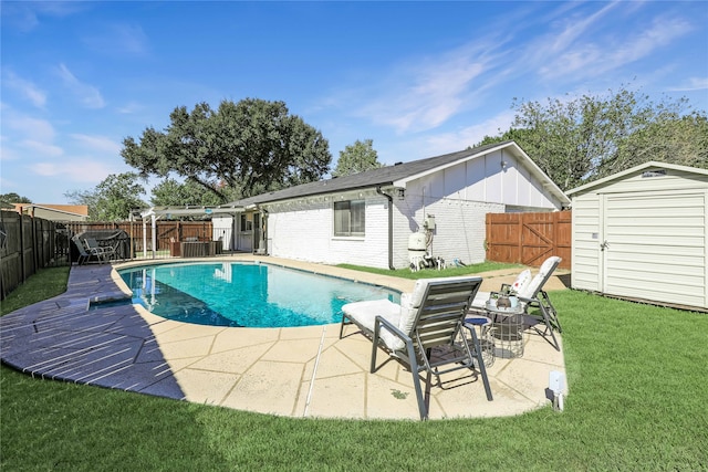 view of pool with a storage unit, a lawn, and a patio area